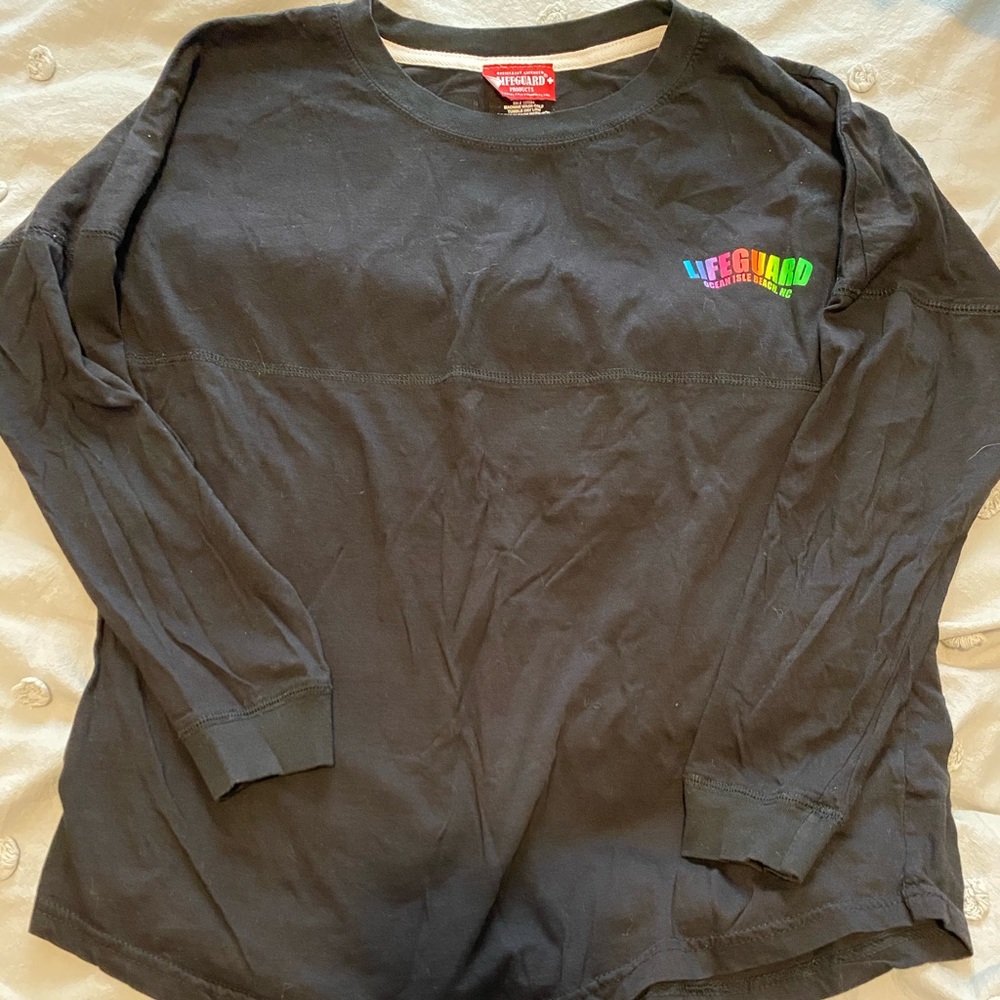 Black long sleeve t-shirt that rainbow lettering.